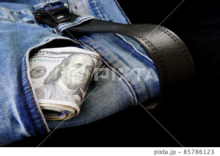 100 usd banknotes visible in the pocket of a jeans lying on the floor, your jeans and 100 usd, 100 usd banknotes visible in the pocket of a jeans lying on the floor, your jeans and 100 usd, 85786123