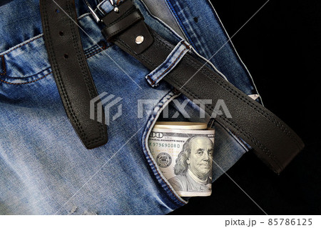 100 usd banknotes visible in the pocket of a jeans lying on the floor, your jeans and 100 usd, 100 usd banknotes visible in the pocket of a jeans lying on the floor, your jeans and 100 usd, 85786125