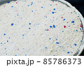 a measure of powdered laundry detergent, close-up laundry detergent, 85786373