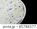 a measure of powdered laundry detergent, close-up laundry detergent, 85786377