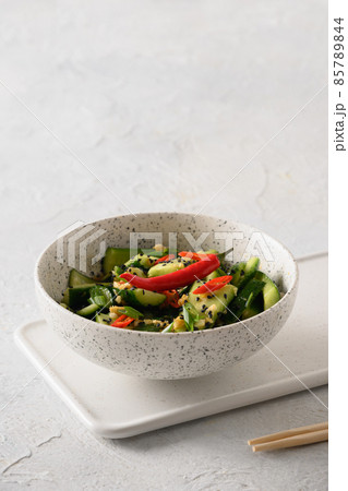 Asian spicy cold appetizer Broken Cucumbers with fresh coriander, ginger, pepper chili, black vinegar. 85789844