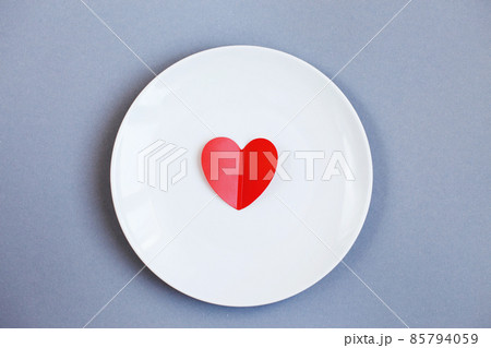 Red Heart on a white plate on grey background 85794059