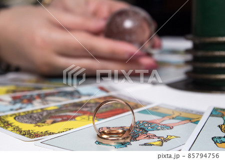 Wedding rings are on Tarot cards. The Gypsy lays out Tarot cards and guesses for the future. Magic sessions with talking Tarot cards with heart and wedding rings Wedding rings are on Tarot cards. The Gypsy lays out Tarot cards and guesses for the future. Magic sessions with talking Tarot cards with heart and wedding rings 85794756