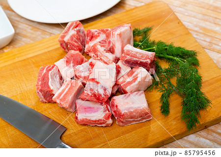 Unprepared pork ribs chopped on table and ready-to-cook Unprepared pork ribs chopped on table and ready-to-cook 85795456