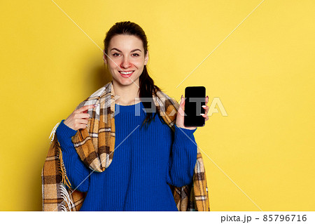 Portrait of Caucasian young woman flu and cold, feeling sick posing isolated on yellow studio background. Portrait of Caucasian young woman flu and cold, feeling sick posing isolated on yellow studio background. 85796716