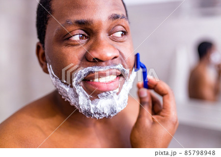 hispanic man put on foam on beard perfume lotion or skin care cream for sensitive skin 85798948