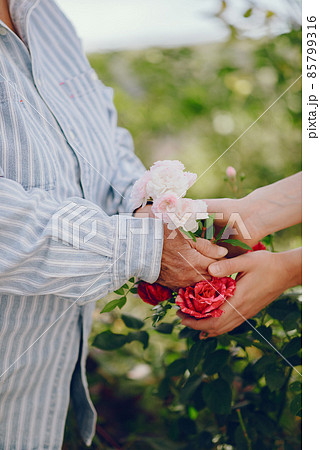 Old woman in a garden with young granddaughter 85799316