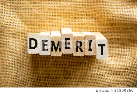 Demerit symbol. The concept word Demerit on wooden blocks. Beautiful canvas background, copy space. Business and demerit concept. 85800860