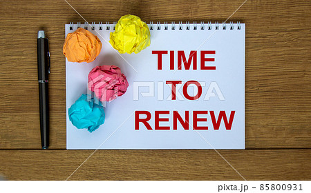 White note with inscription 'time to renew' on beautiful wooden table, colored paper, pen, cap. Business concept. 85800931
