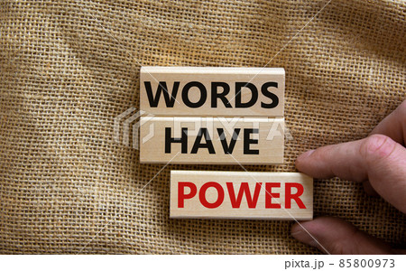 Wooden blocks form the words 'words have power' on canvas background. Male hand. Business concept. Wooden blocks form the words 'words have power' on canvas background. Male hand. Business concept. 85800973