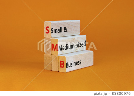 SMB small and medium-sized business symbol. Words SMB small and medium-sized business on blocks on a beautiful orange background. Business and SMB small and medium-sized business concept. Copy space. 85800976