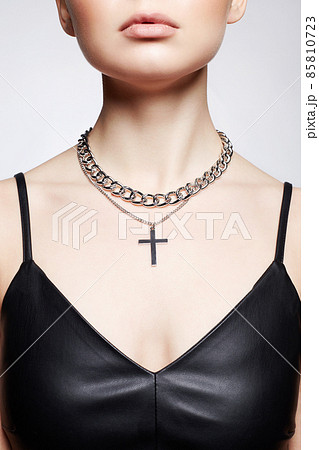 Beautiful young woman with elegant necklace. girl in leather dress 85810723