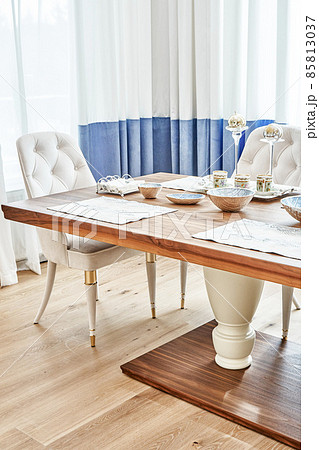 Dining table of walnut with festive setting and armchairs Dining table of walnut with festive setting and armchairs 85813037