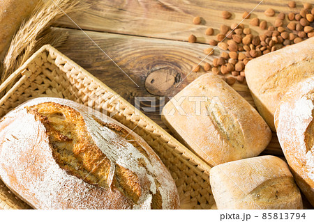 Shop decoration of a traditional bakery with fresh bread, rolls and ears of ripe rye and bitter peach kernels. Bakery with taste. Shop decoration of a traditional bakery with fresh bread, rolls and ears of ripe rye and bitter peach kernels. Bakery with taste. 85813794