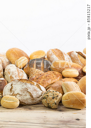 Many kinds and kinds of bread collected in one place on a wooden old shop counter as a decoration for a traditional bakery. White background from the top for self-completion. Many kinds and kinds of bread collected in one place on a wooden old shop counter as a decoration for a traditional bakery. White background from the top for self-completion. 85815217