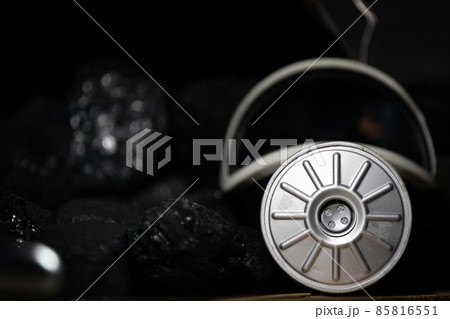 Dust mask with filter lies on black coal background for mine rescuers Dust mask with filter lies on black coal background for mine rescuers 85816551