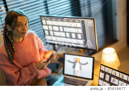 Photographer editing photos at home office Photographer editing photos at home office 85816677