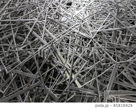 full frame abstract industrial background of stamping leftovers pile, close-up with selective focus full frame abstract industrial background of stamping leftovers pile, close-up with selective focus 85816926