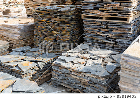 Pallets with natural stone tiles in a warehouse of brick factory 85819405