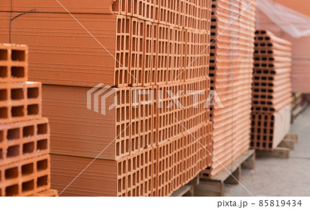 Pallets with stack of redbricks lying at warehouse Pallets with stack of redbricks lying at warehouse 85819434