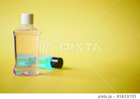 mouthwash liquid in a container on yellow background mouthwash liquid in a container on yellow background 85819705