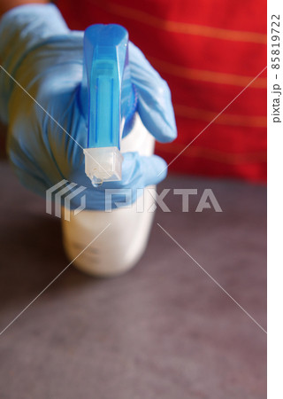using disinfectant spray to clean table surface using disinfectant spray to clean table surface 85819722