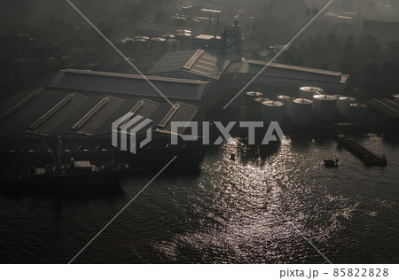 Aerial view overlooking of Oil and gas refinery industrial factory, Pier and Cargo ship along Chao phraya river. Aerial view overlooking of Oil and gas refinery industrial factory, Pier and Cargo ship along Chao phraya river. 85822828