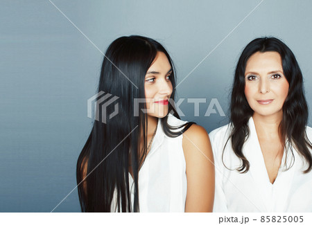 cute pretty teen daughter with mature mother hugging, fashion style brunette, lifestyle people concept 85825005