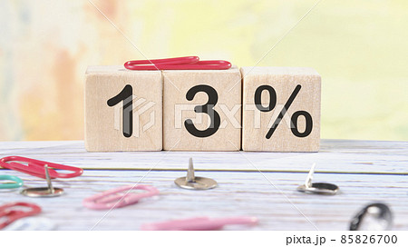 13 Percent text written on wooden cubes on a light colored background 85826700