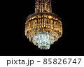 Contemporary glass chandelier isolated over black background 85826747