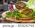 wrap sandwich with ham, lettuce, ruccola and cheeses 85826748