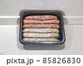 Fresh peppered raw sausages ready for frying 85826830