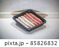 Fresh peppered raw sausages ready for frying 85826832
