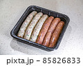 Fresh peppered raw sausages ready for frying 85826833