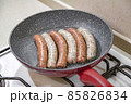 Fresh peppered raw sausages ready for frying 85826834