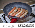 Fresh peppered raw sausages ready for frying 85826835