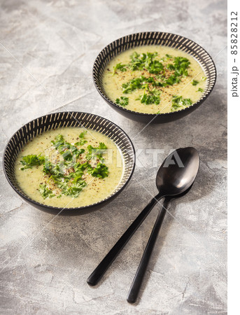 Homemade broccoli cream soup on light background. 85828212
