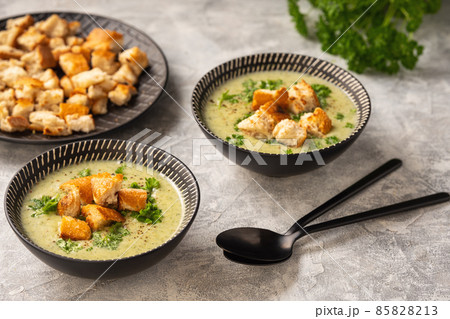 Homemade broccoli cream soup on light background. 85828213