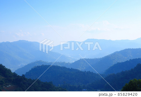 Mountain range with visible silhouettes through the morning colorful fog.with sunlight romanctic moment 85829420