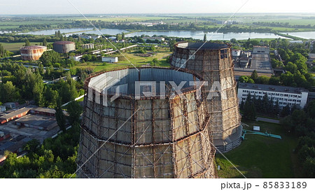 Aerial drone view flight near thermal power plant. Cooling towers of CHP Aerial drone view flight near thermal power plant. Cooling towers of CHP 85833189