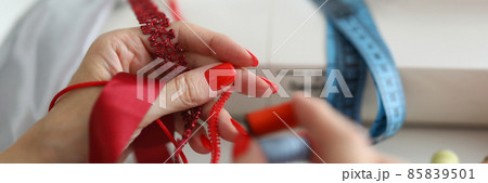 Woman works with applique made of lace and silk Woman works with applique made of lace and silk 85839501
