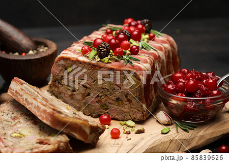 Traditional French terrine covered with bacon on dark wooden background Traditional French terrine covered with bacon on dark wooden background 85839626