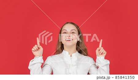 kid in white shirt raised fingers up on red background. childhood. cheerful child portrait. 85841350