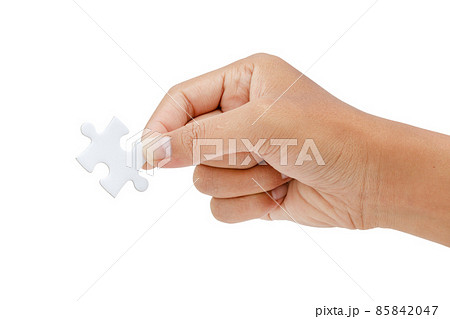 hand trying to connect jigsaw puzzle piece isolated on white background - clipping paths hand trying to connect jigsaw puzzle piece isolated on white background - clipping paths 85842047
