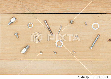 metal bolt and nut on wooden background. metal bolt and nut on wooden background. 85842561