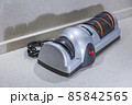 Modern electric knife sharpener in the home kitchen 85842565