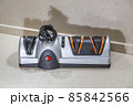 Modern electric knife sharpener in the home kitchen 85842566
