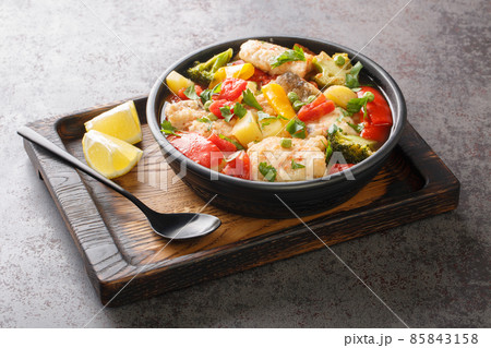 Homemade white sea fish stew with vegetables close-up in a bowl. horizontal Homemade white sea fish stew with vegetables close-up in a bowl. horizontal 85843158