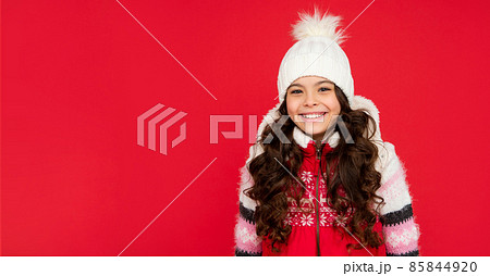 portrait of child wearing warm clothes. express positive emotion. winter fashion. copy space. 85844920