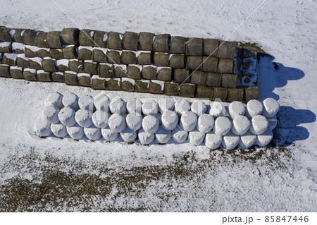 Stack of hay bales in winter near farm, aerial Stack of hay bales in winter near farm, aerial 85847446